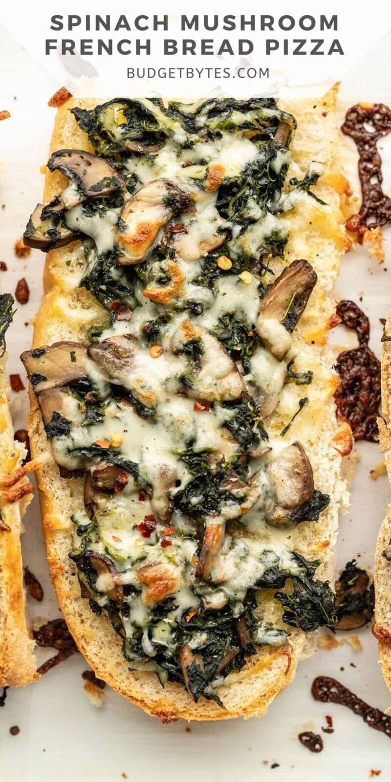 Close up of a spinach mushroom French bread pizza.