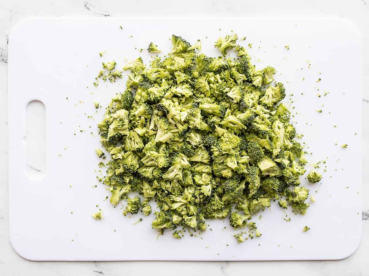 Chopped broccoli on a cutting board.