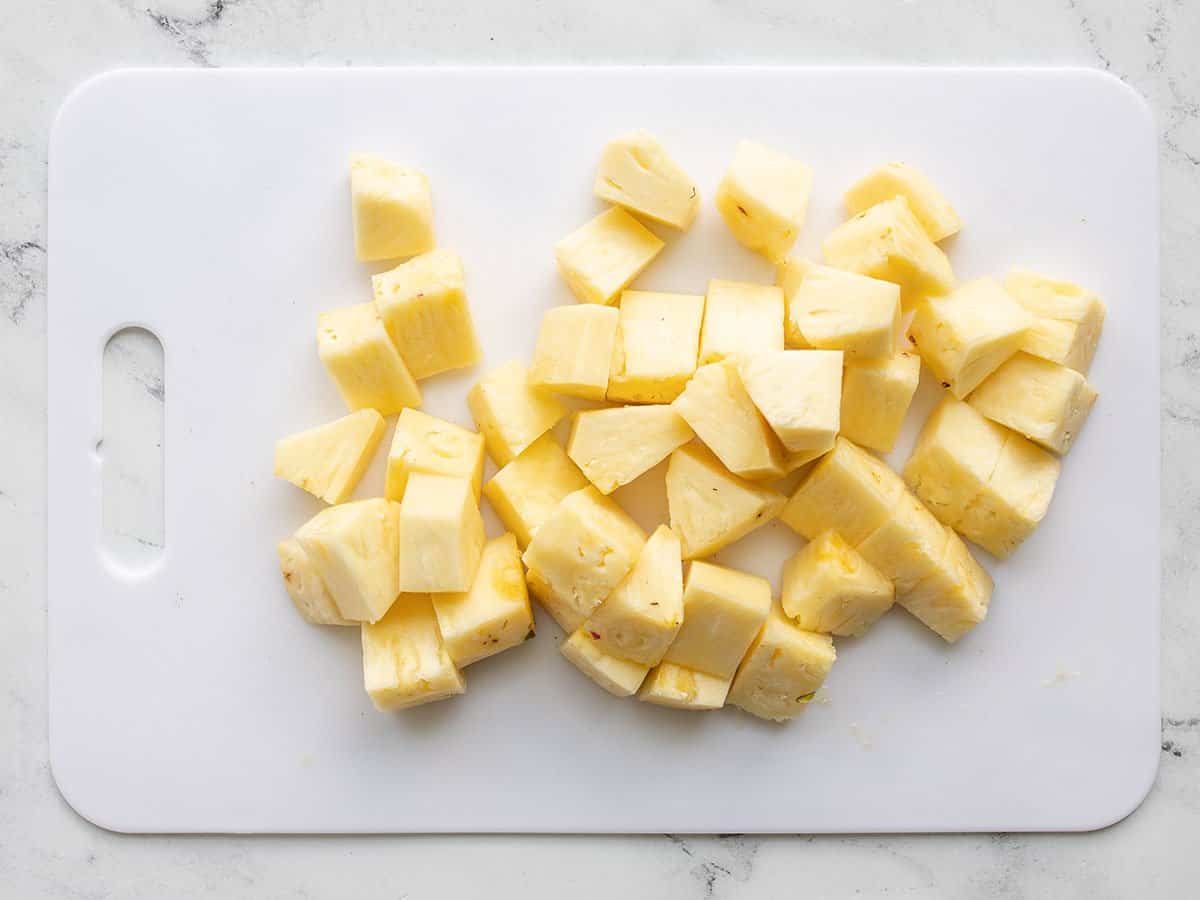 Fresh cut pineapple on a cutting board.