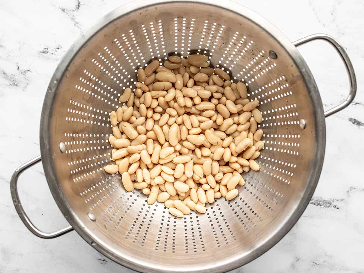 Cannellini beans draining in a colander.