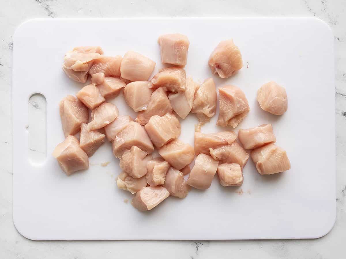 Diced chicken breast on a cutting board.