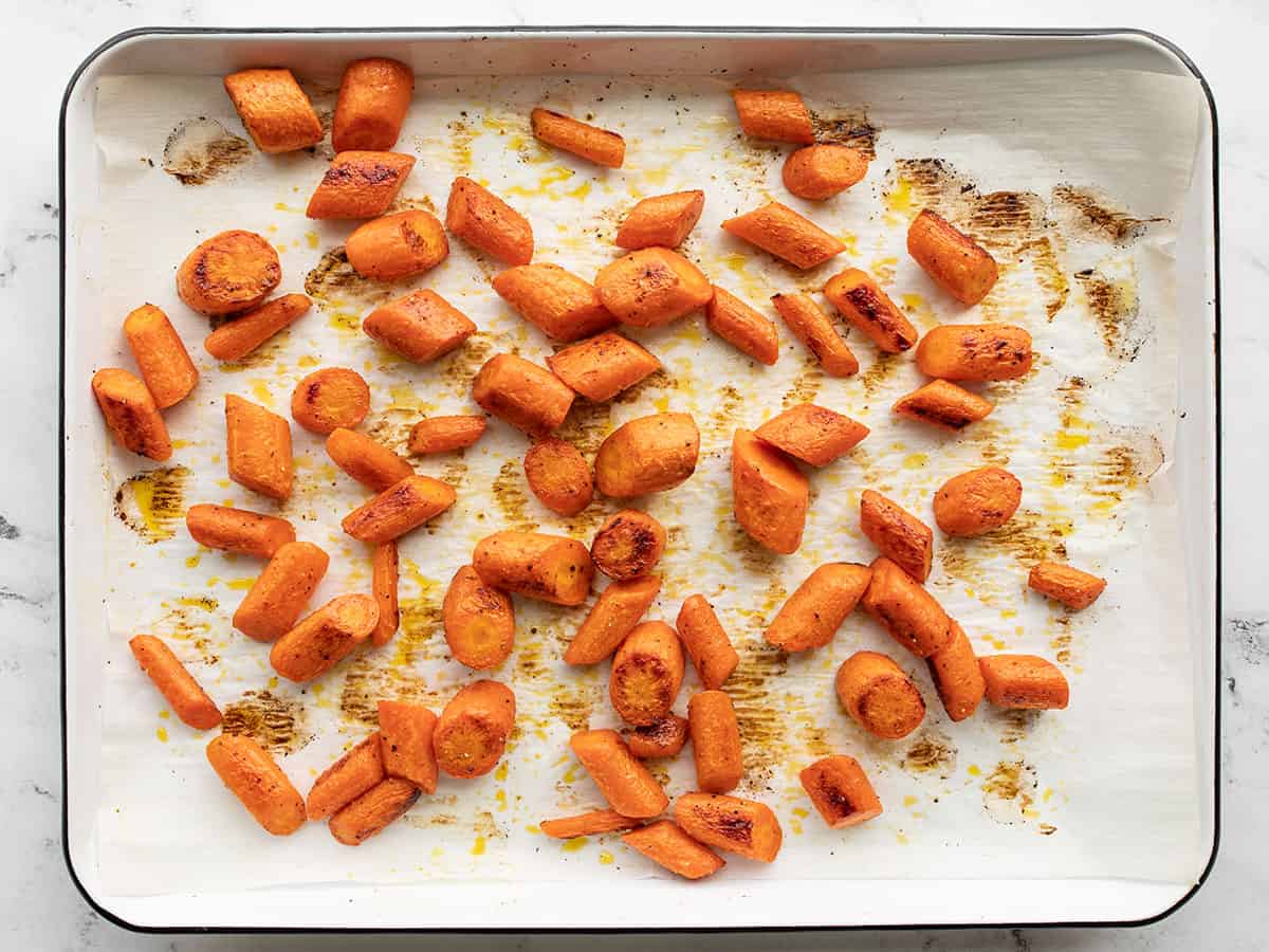 Fried carrots on a baking sheet.