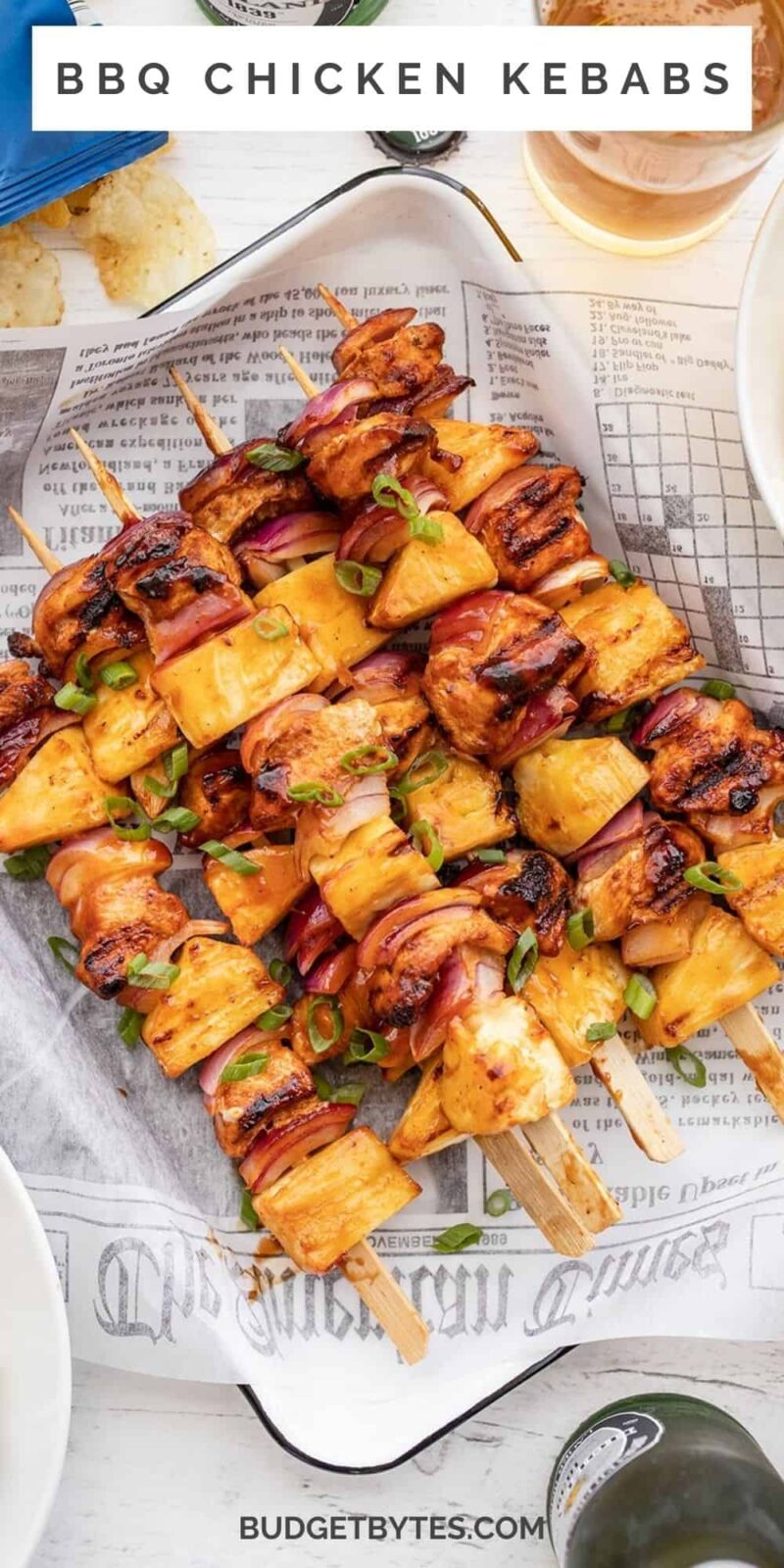 BBQ chicken kebabs on a tray lined with paper.