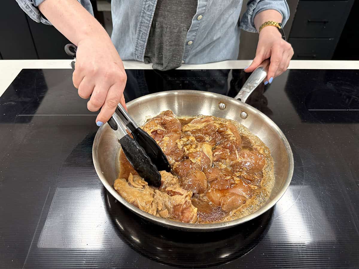 Teriyaki chicken being cooked in a skillet.