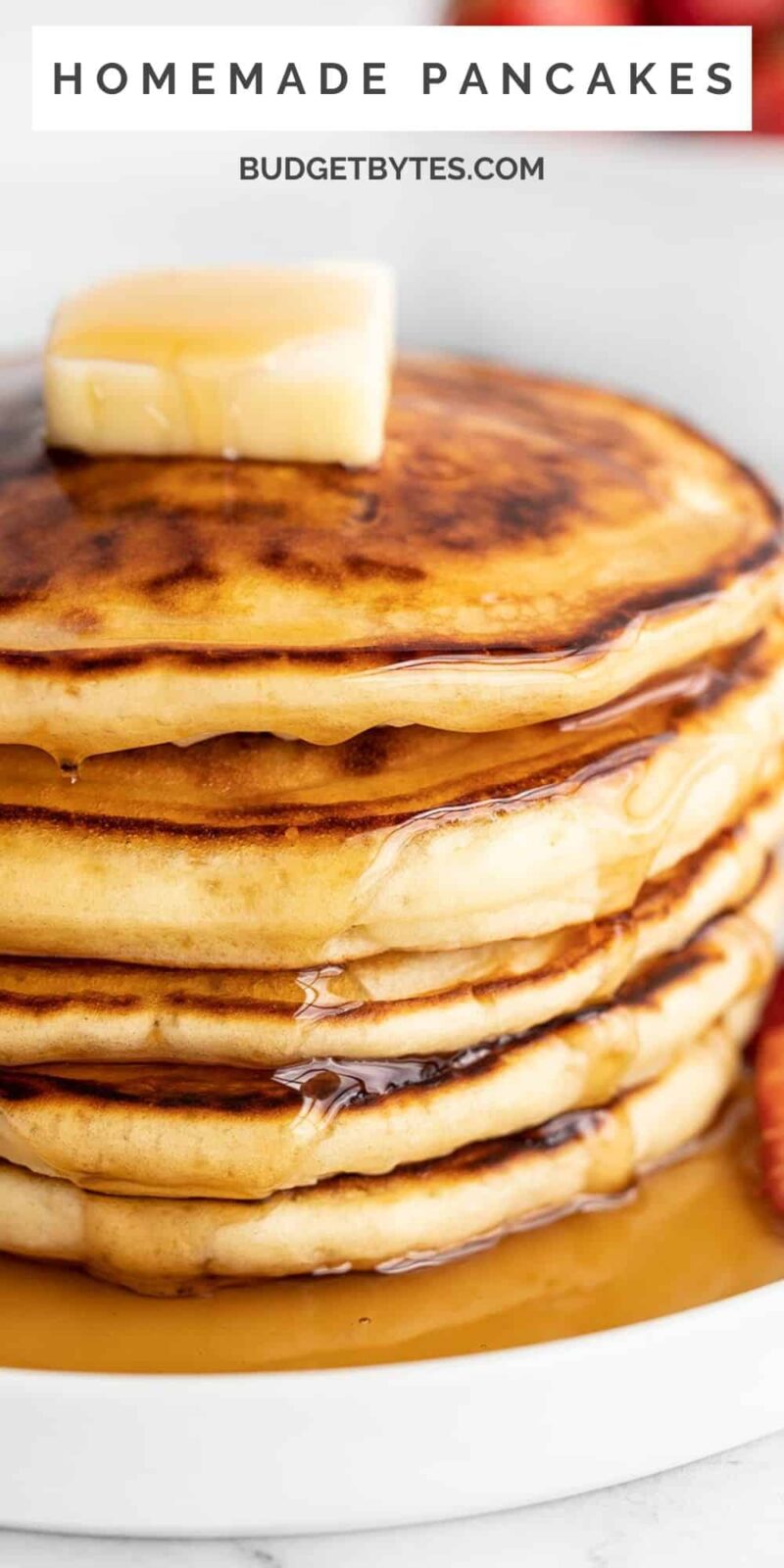 Close up side view of a stack of pancakes with syrup.