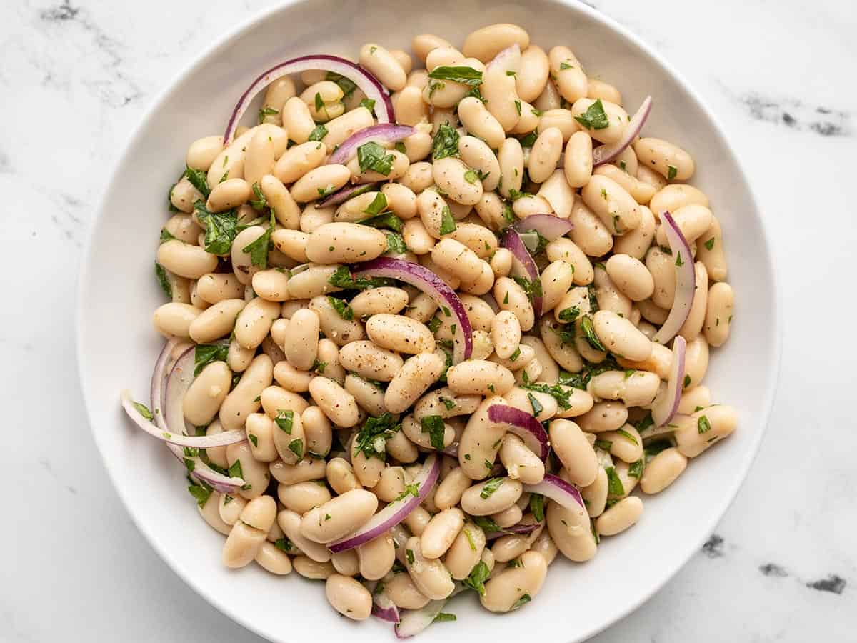 Overhead view of a bowl of lemony white bean salad.