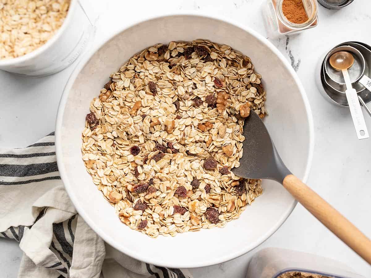 Overhead view of a bowl full of muesli with ingredients on the sides.