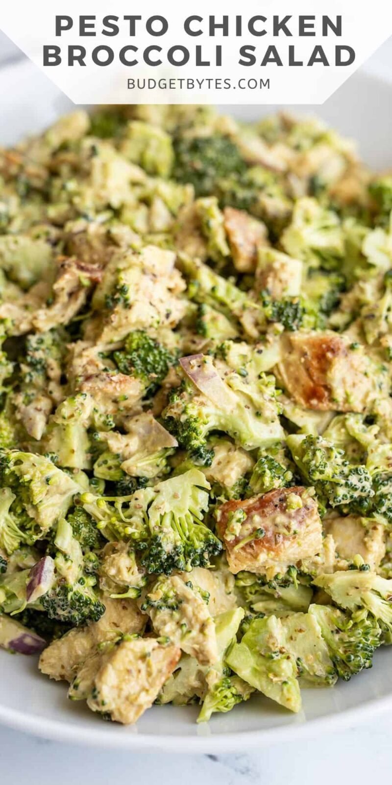 Close up of pesto chicken and broccoli salad in a bowl, title text at the top.