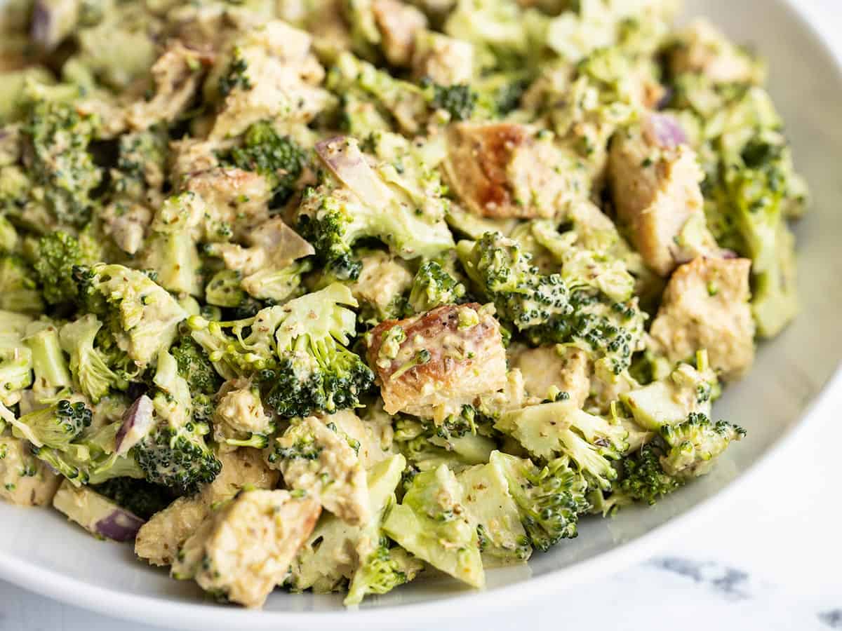 Close up side view of Pesto Chicken and Broccoli Salad in a bowl.