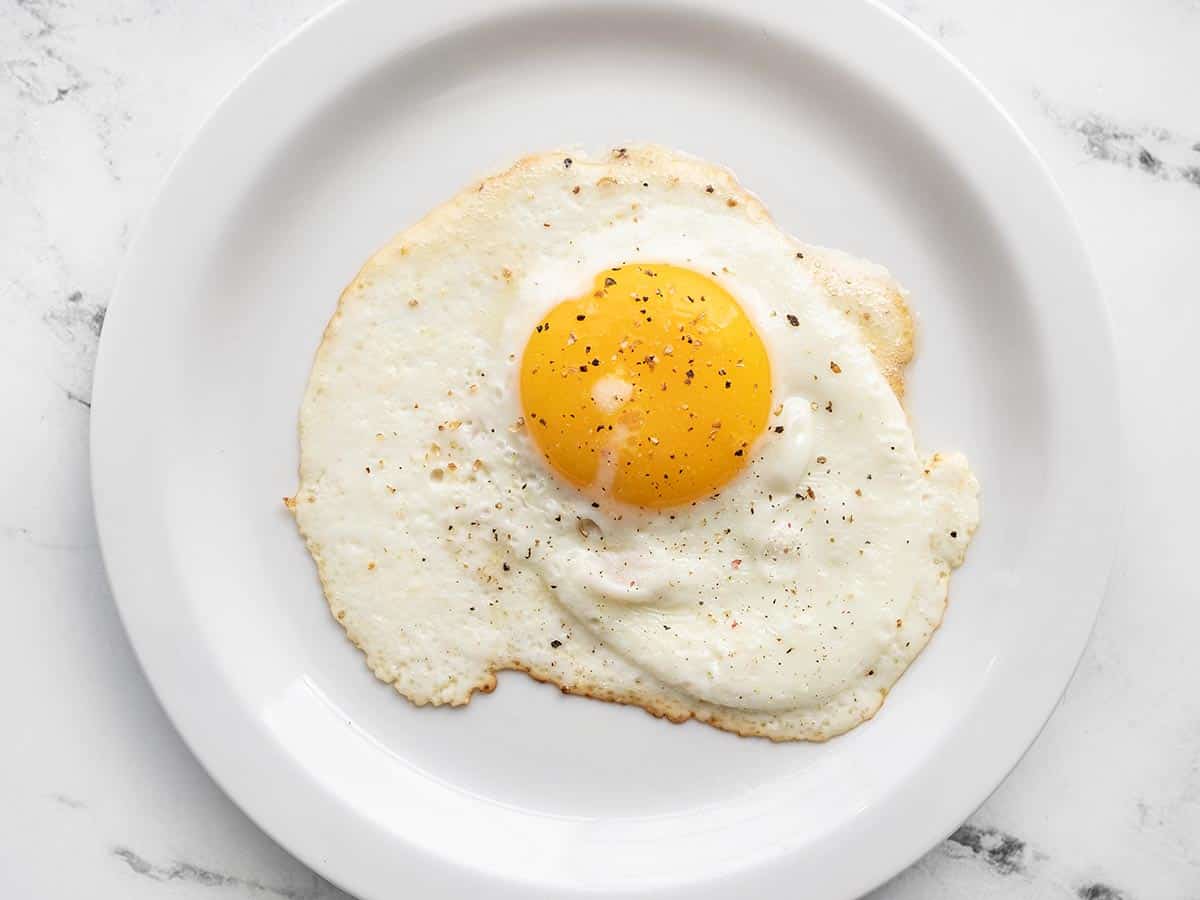 A sunny side up egg on a plate.