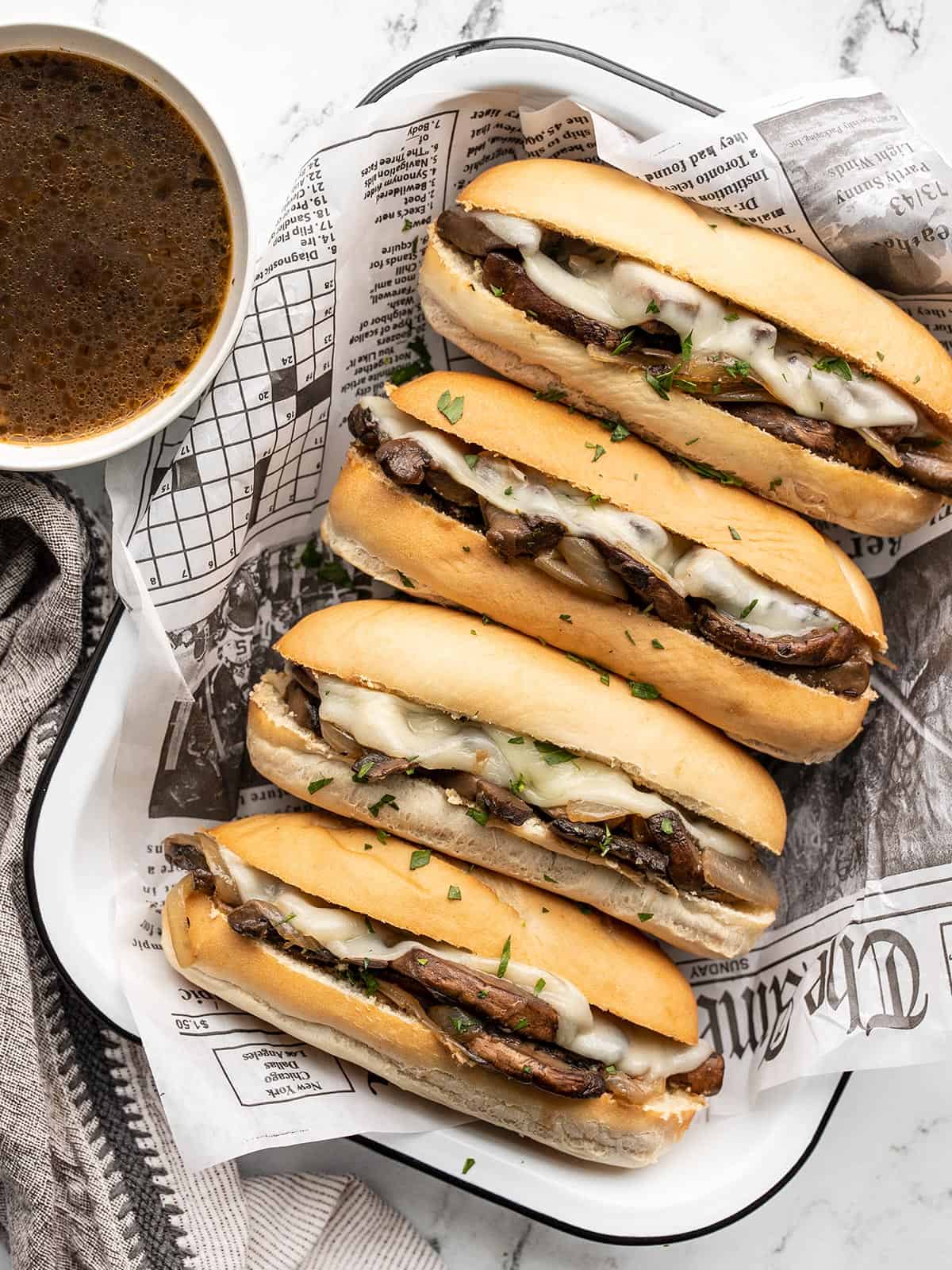 Overhead view of vegetarian French dip sandwiches in a tray.