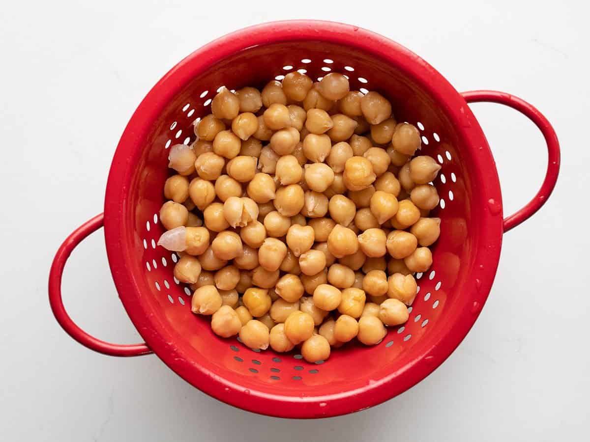 Rinsed Chickpeas in a red colander.