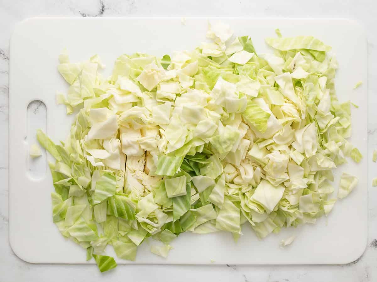 Chopped cabbage on a cutting board.