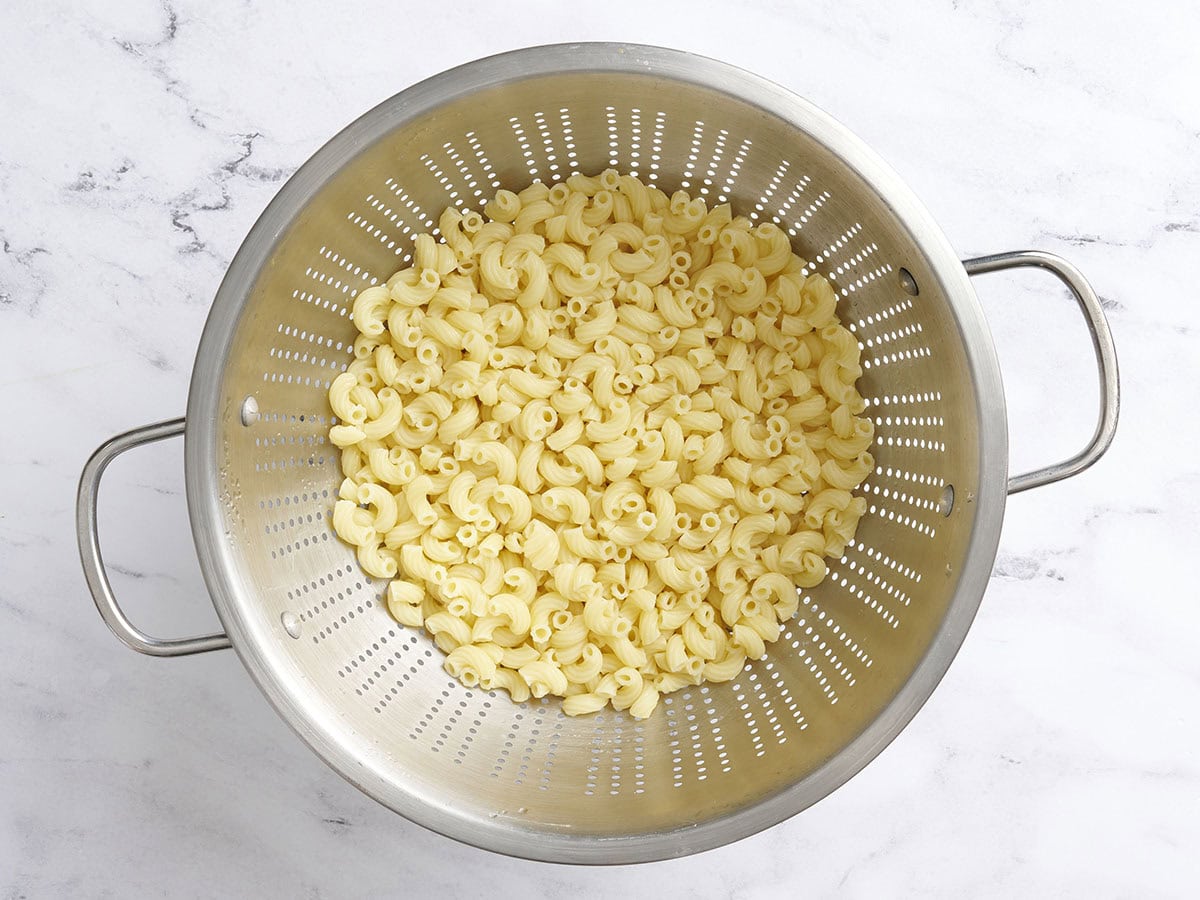 Cooked macaroni in a colander.