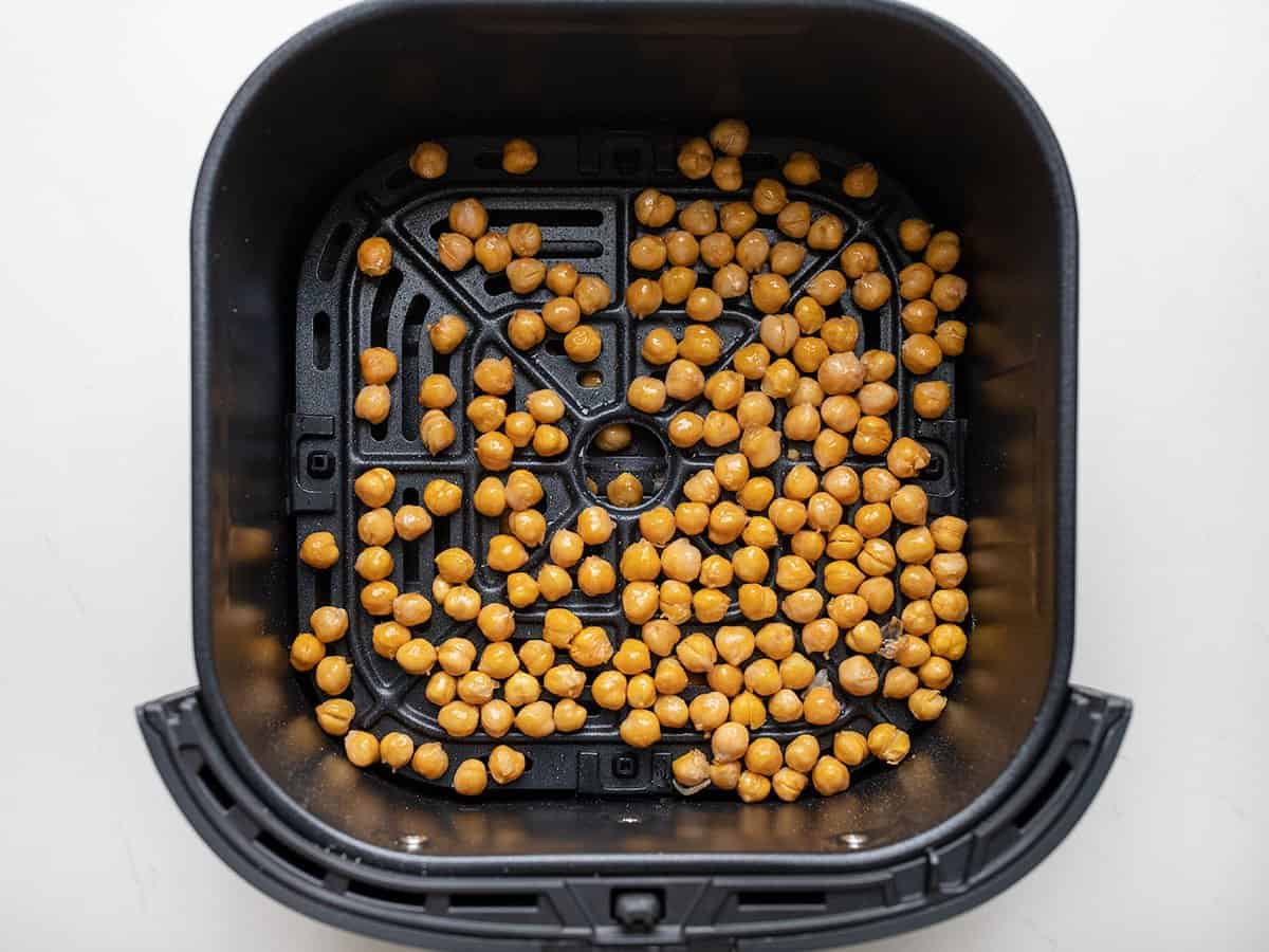 Half-cooked chickpeas in the air fryer basket.