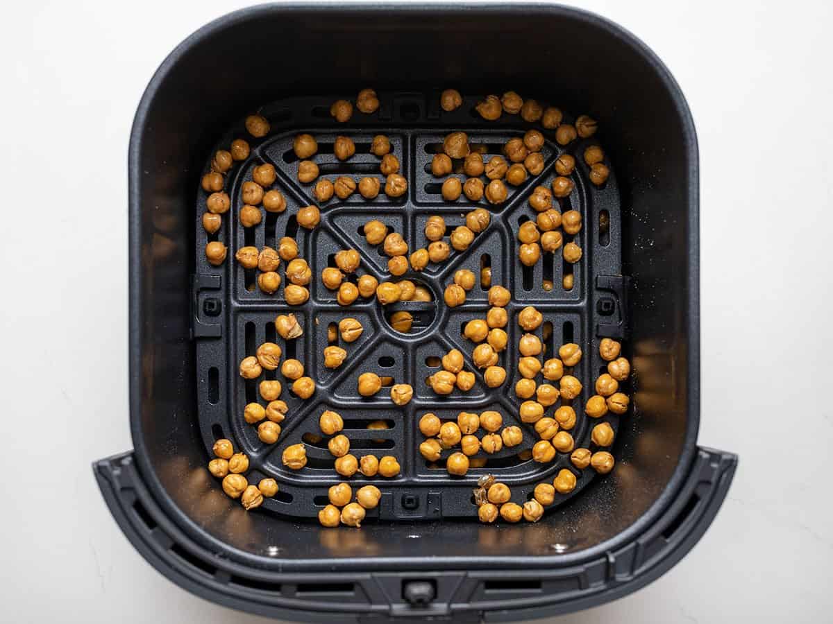 Crispy air-fried chickpeas in the air fryer basket.