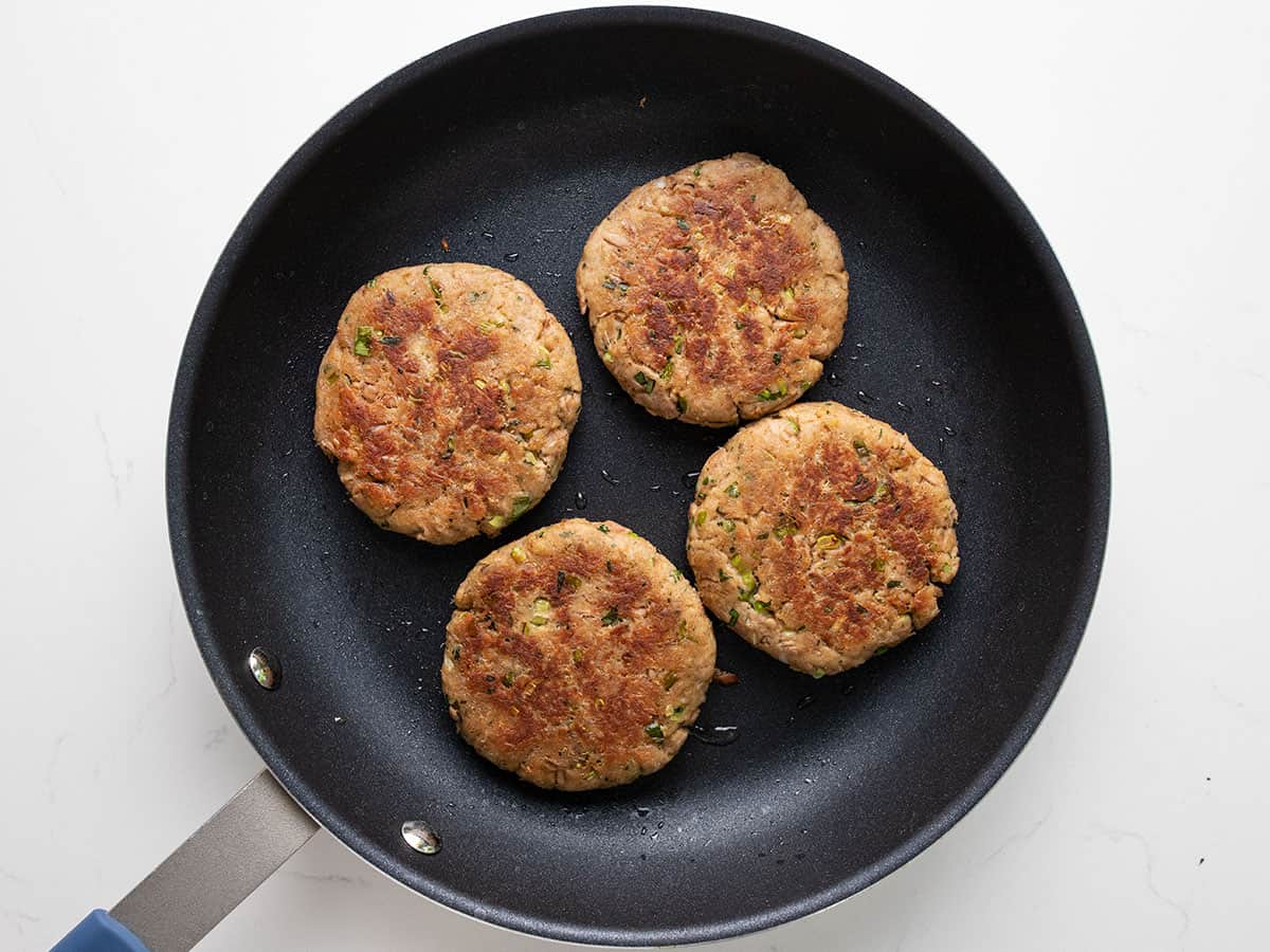 Browned tuna patties in the skillet.