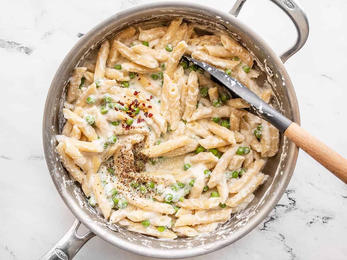 Salt, pepper, and red pepper added to the pasta.