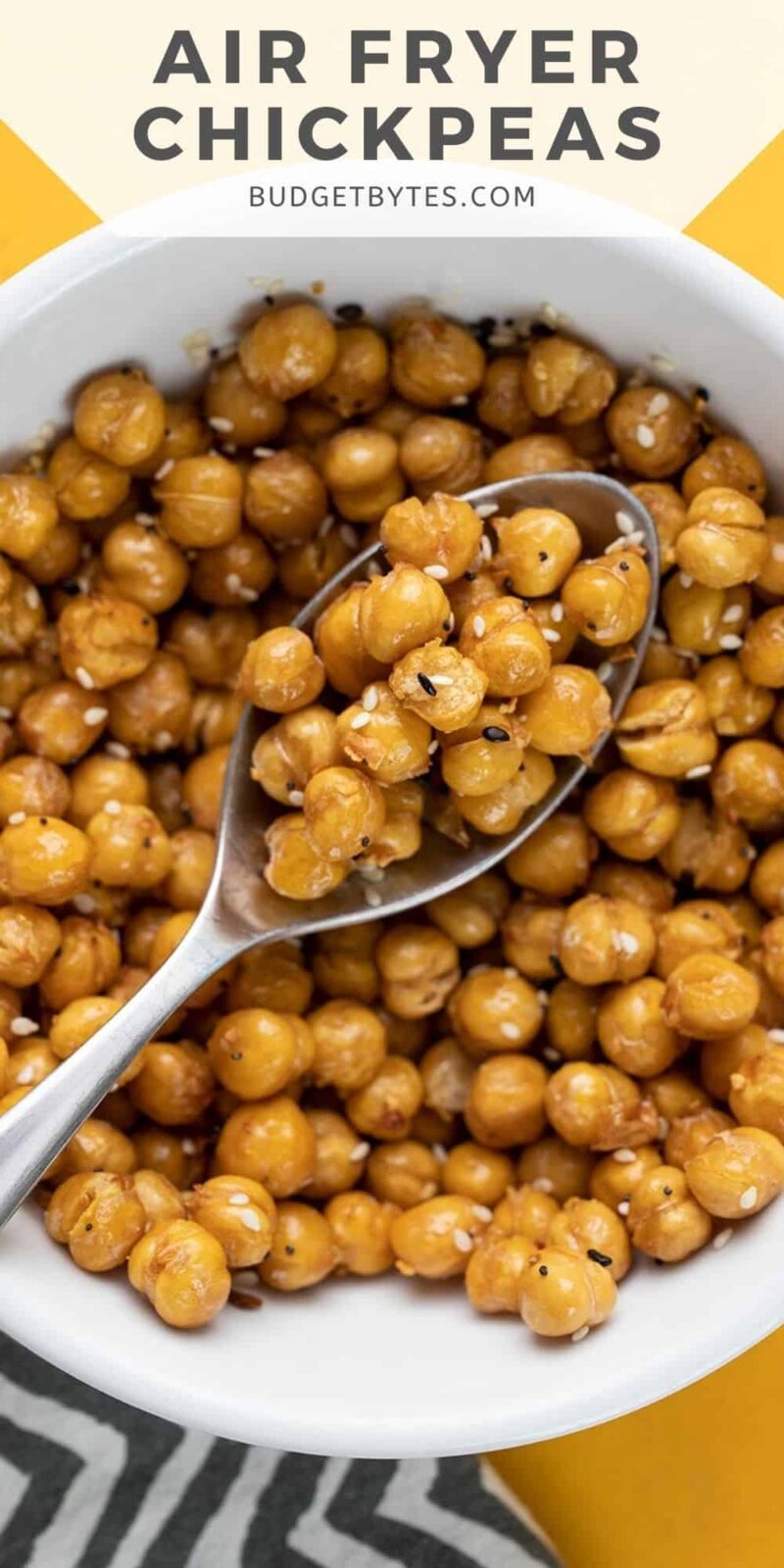 Close up overhead view of a bowl of air fryer chickpeas with a spoon.