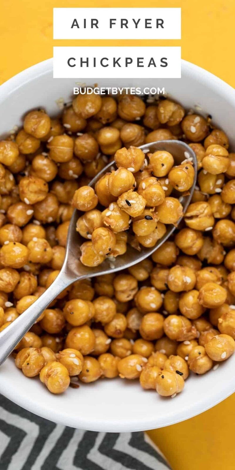 Close up overhead view of a bowl full of air fried chickpeas with a spoon.