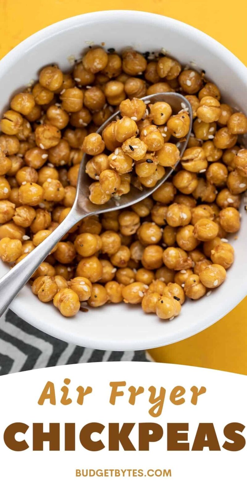 Close up overhead view of a bowl full of air fried chickpeas with a spoon.