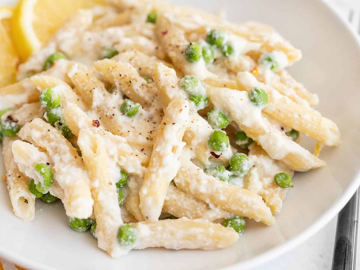 close up side view of lemon ricotta pasta in a bowl.