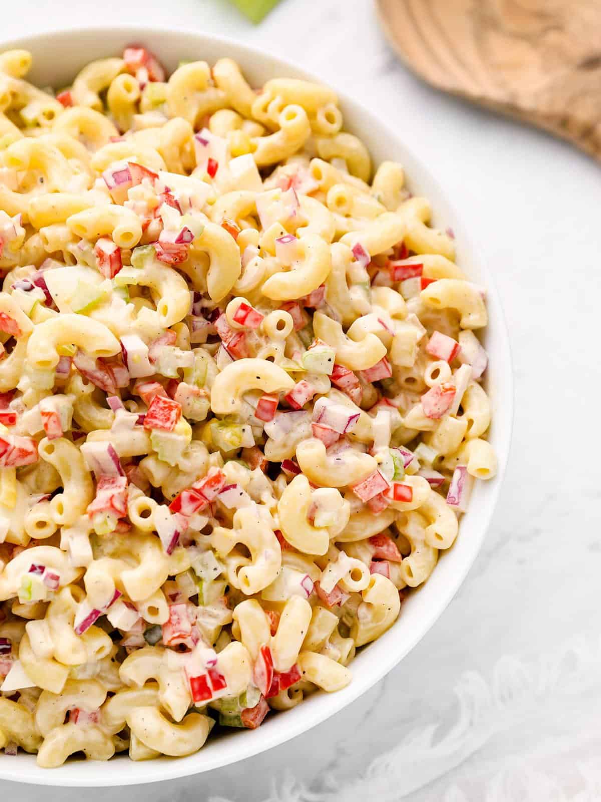 close up side view of macaroni salad in a bowl.