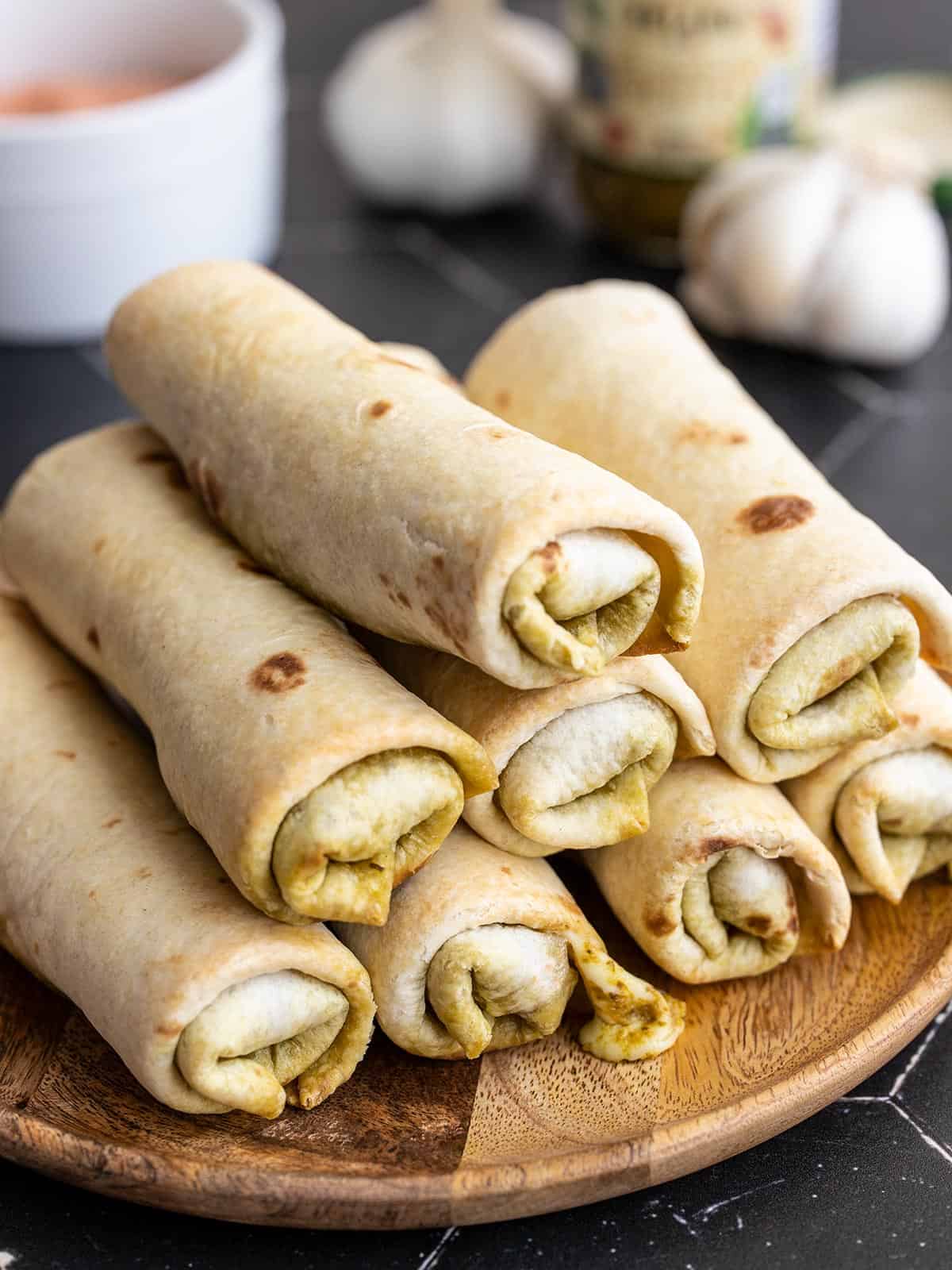 side view of a plate full of pesto mozzarella roll ups.