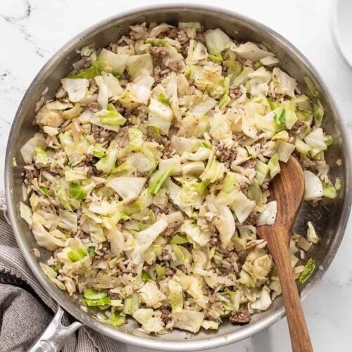 Overhead view of the finished sautéed beef, cabbage, and rice in the skillet.