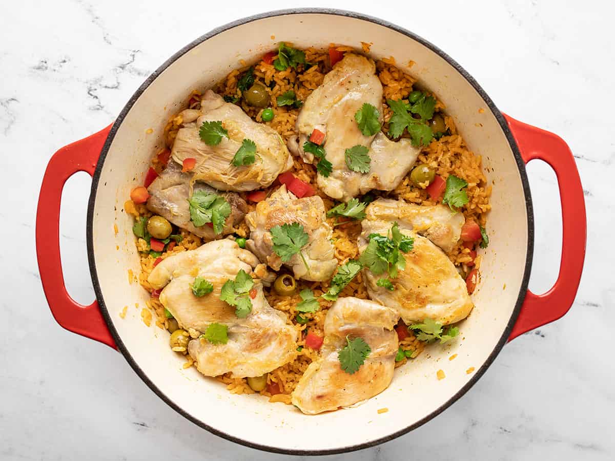 Finished arroz con pollo in a red Dutch oven.