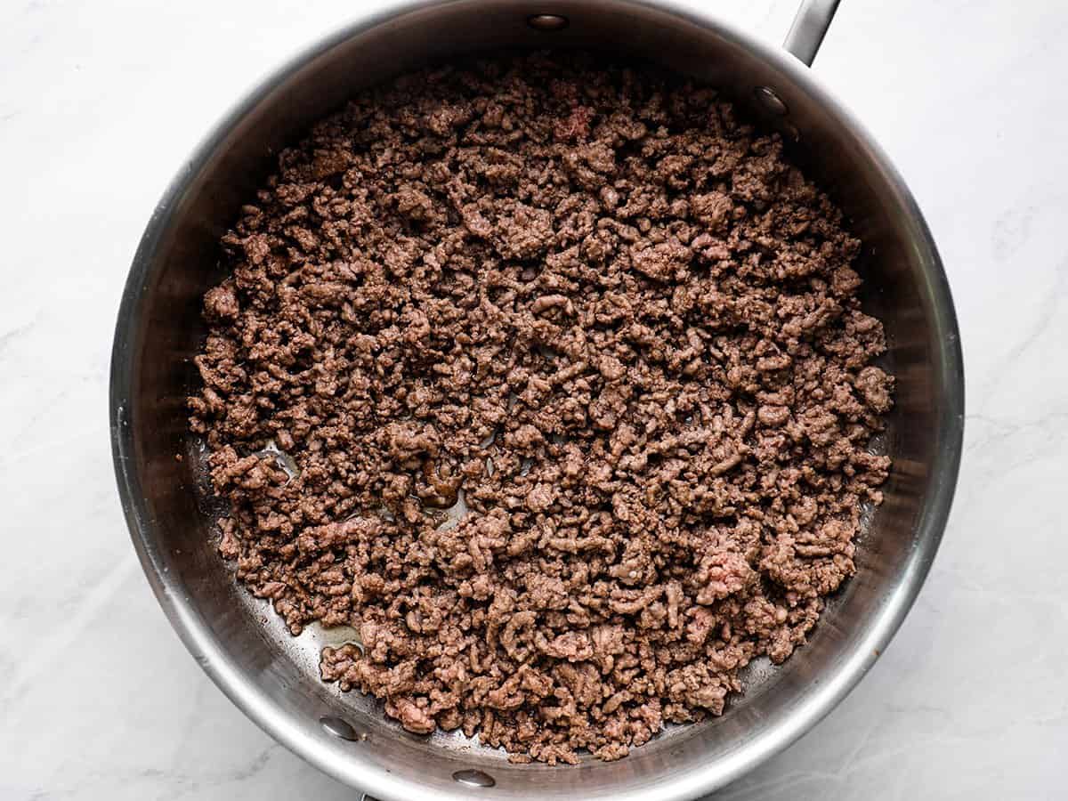 Browned ground beef in a skillet.