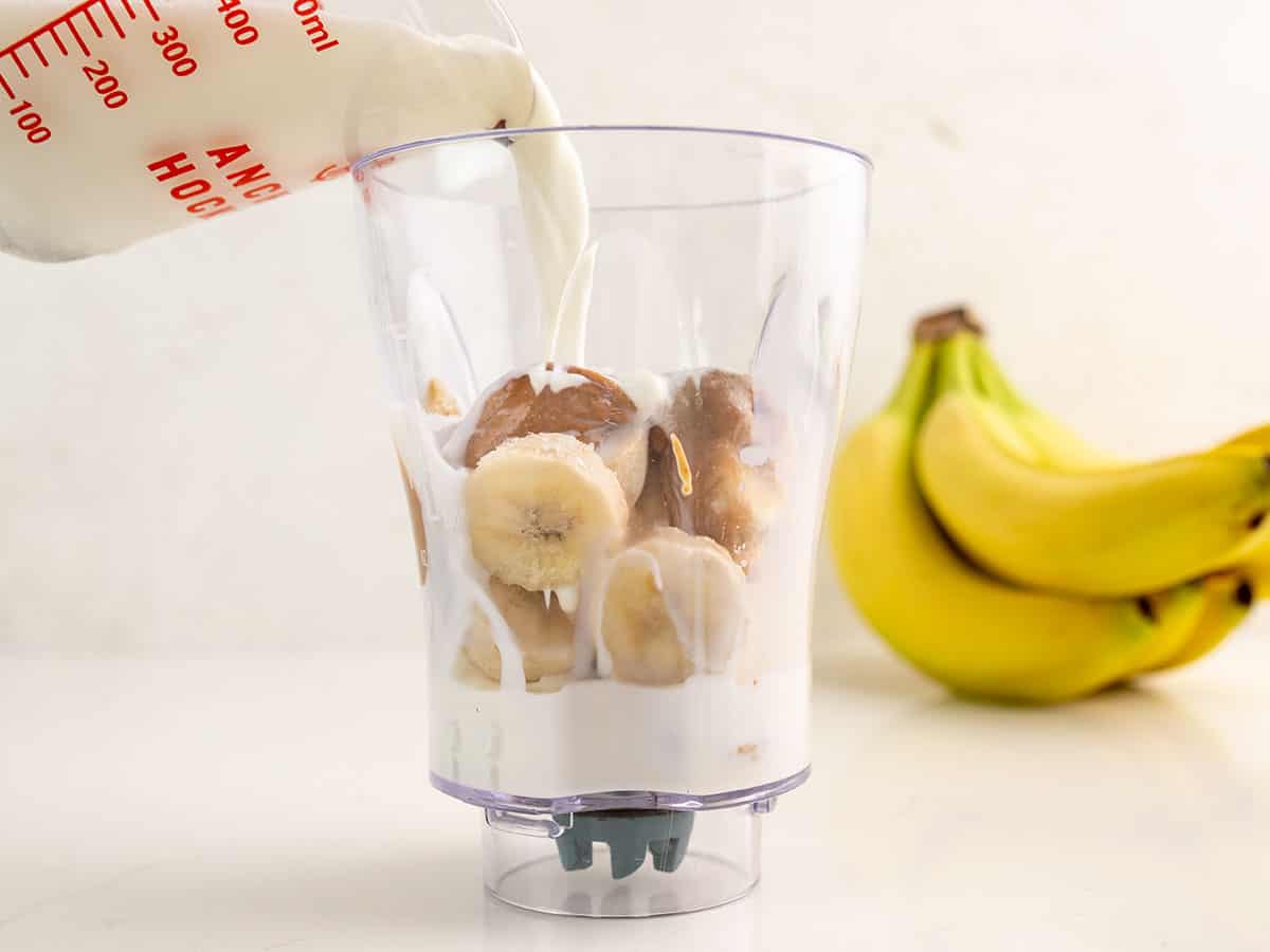 Milk being poured into the blender cup.