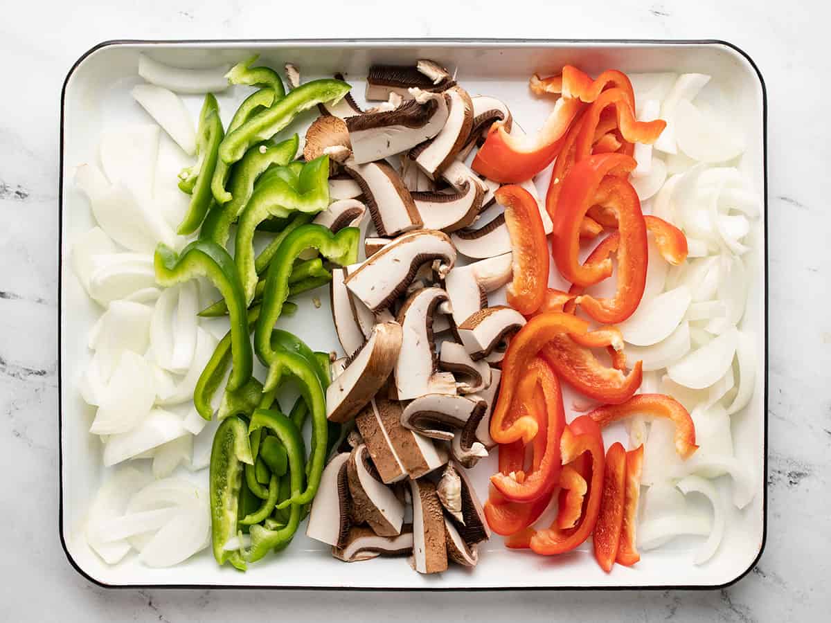 Sliced vegetables on a baking sheet.