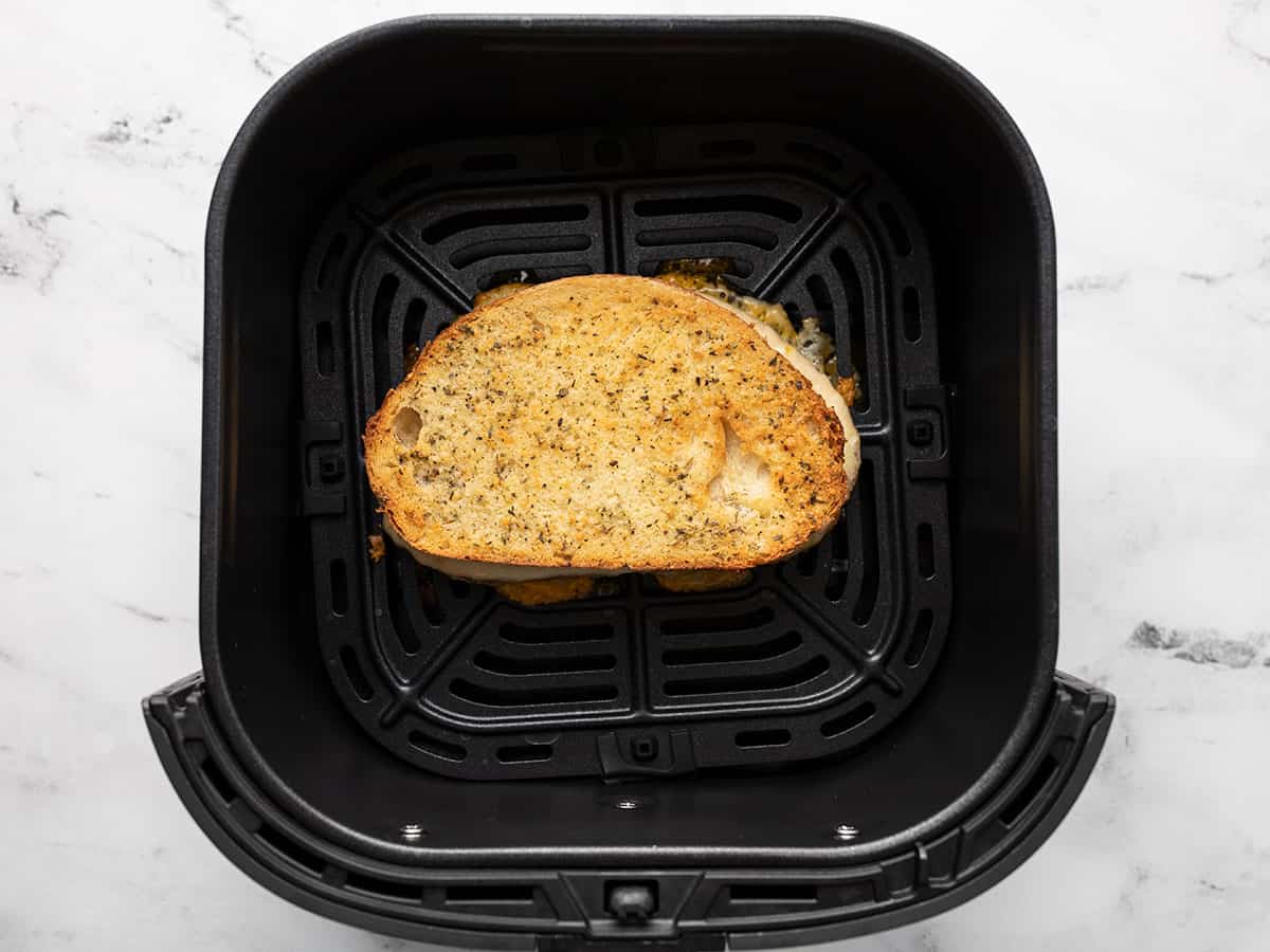 Air fryer grilled cheese in air fryer basket.