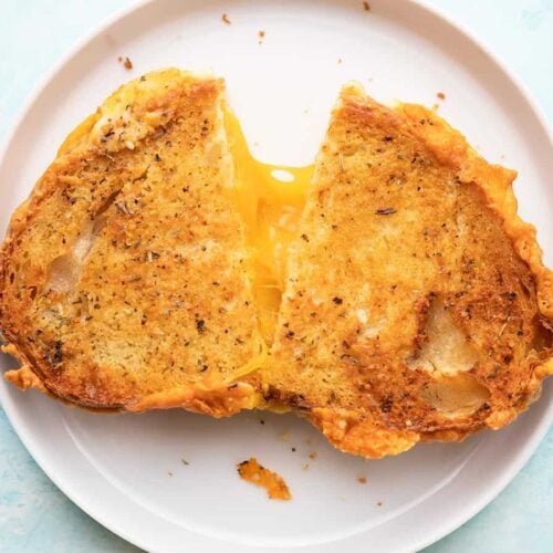 Air Fryer Grilled Cheese on plate, split down middle.