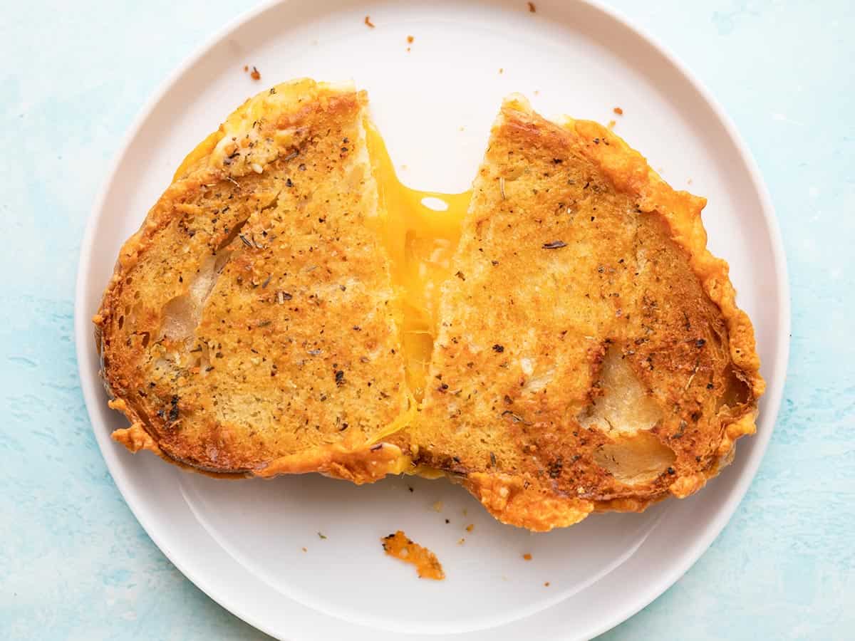Air Fryer Grilled Cheese on plate, split down middle.