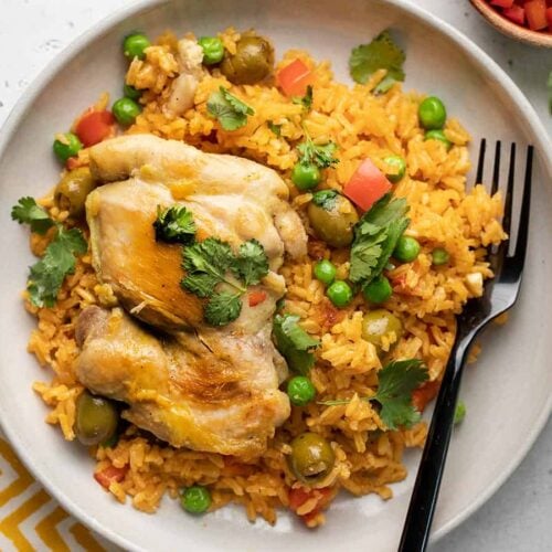 Arroz con Pollo on a plate with a fork.