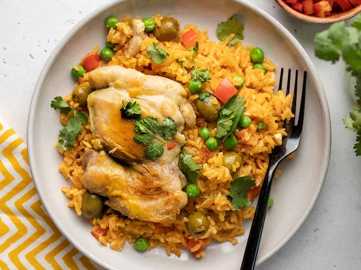 Arroz con Pollo on a plate with a fork.