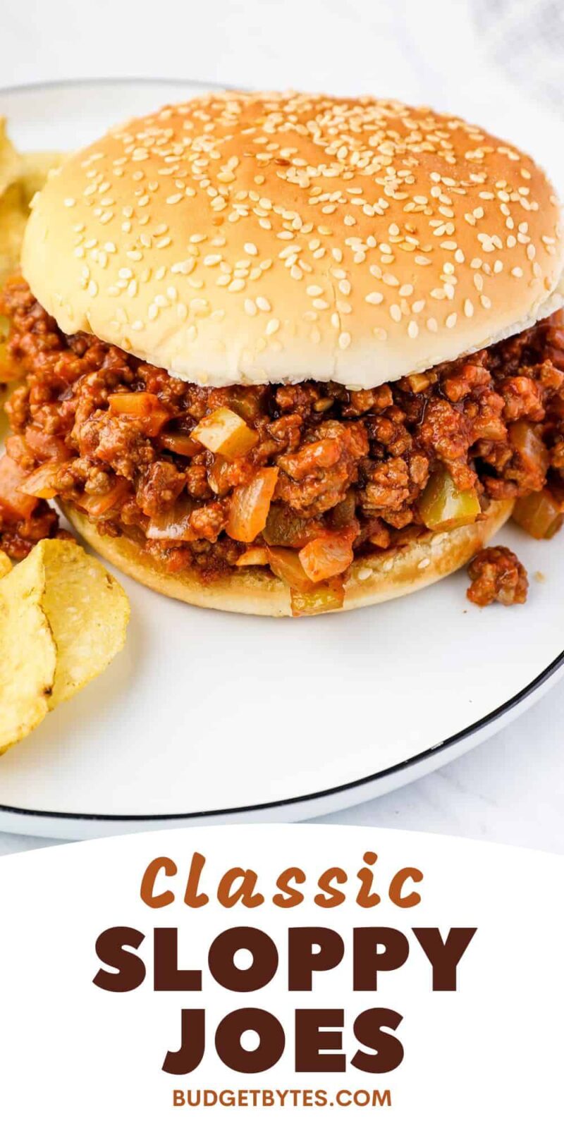 Sloppy joe on a plate with chips.