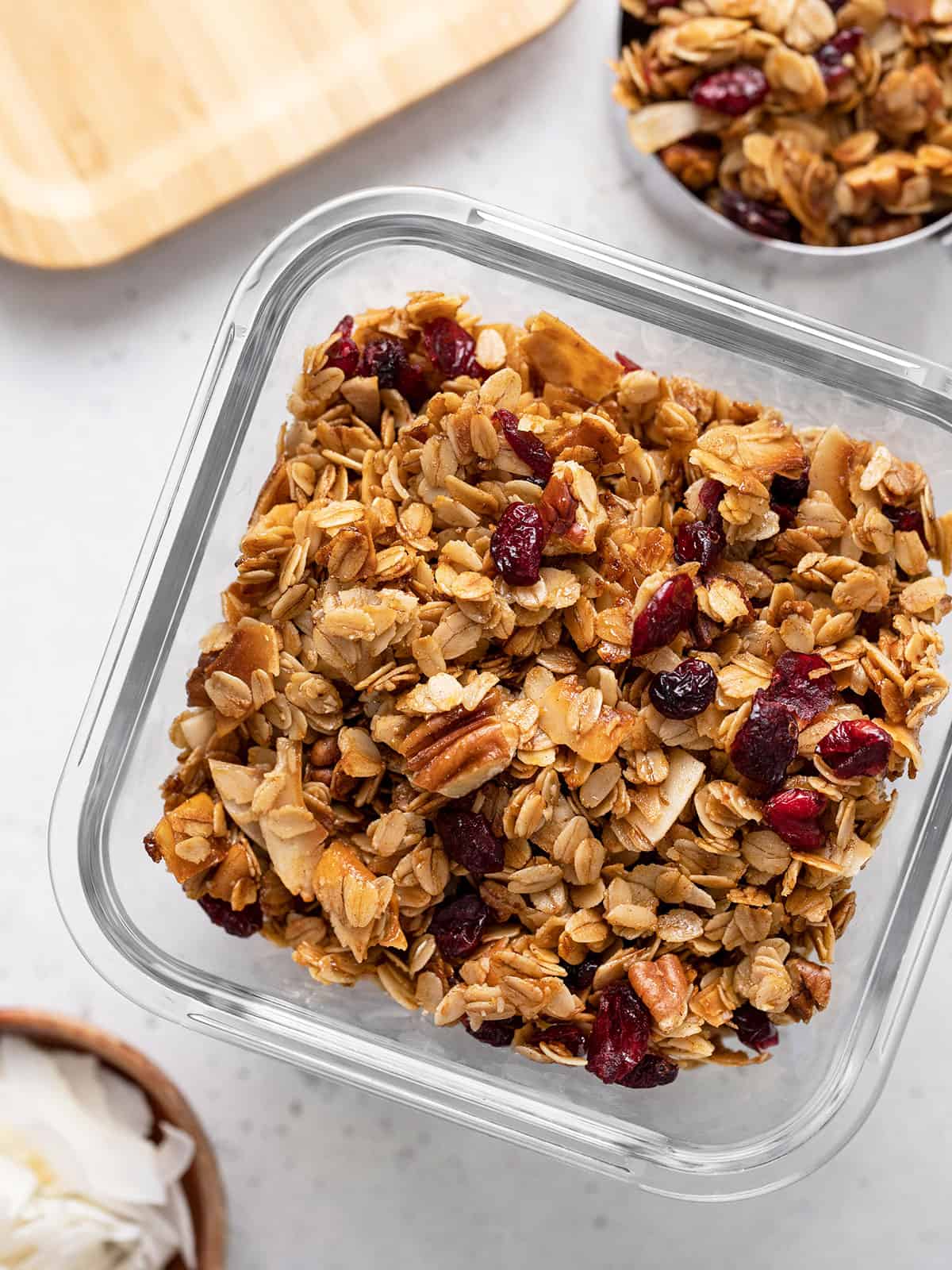 Overhead view of homemade granola in a glass storage container.