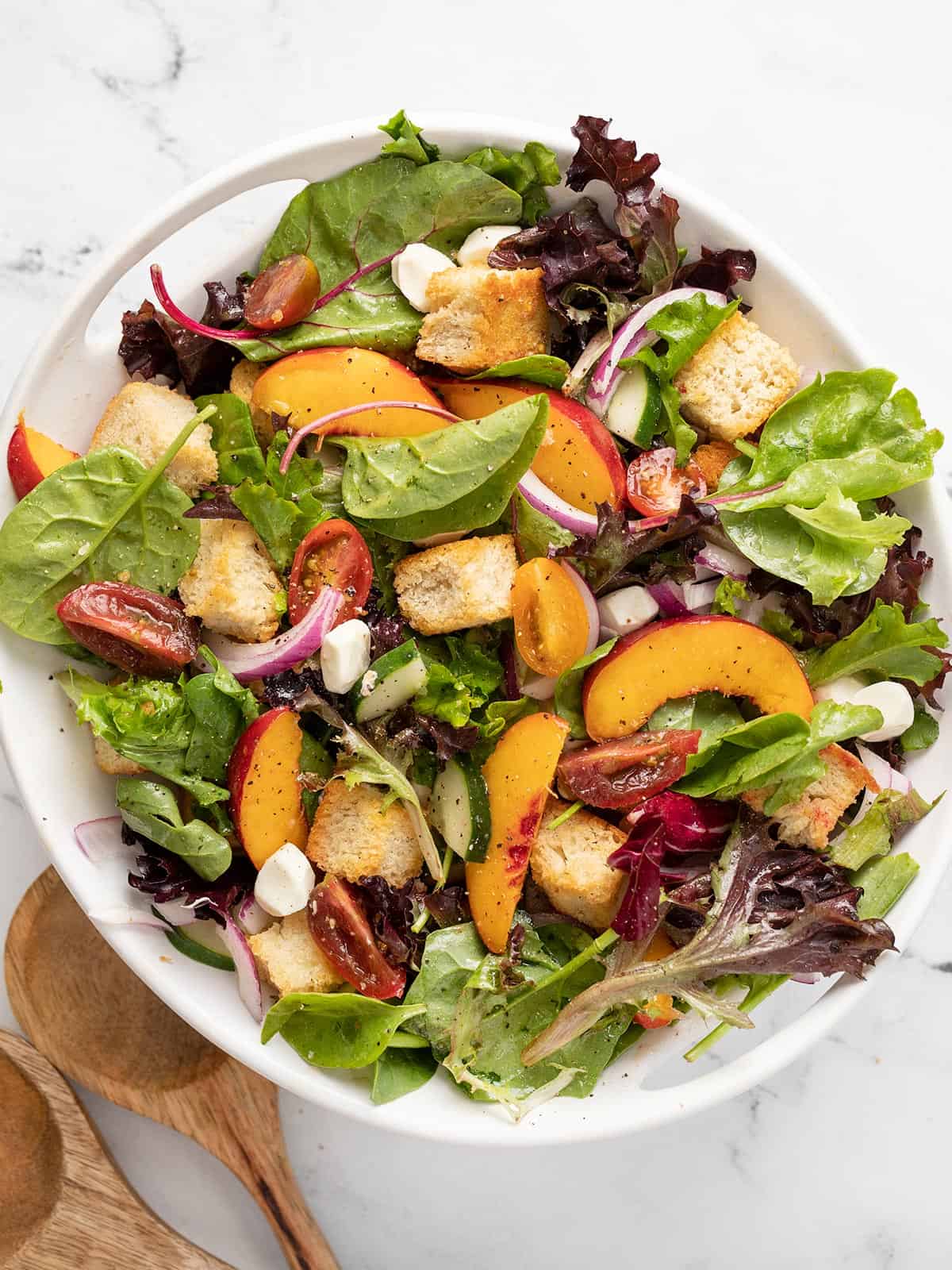 Overhead shot of panzanella salad in a white bowl.