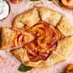 Overhead shot of peach galette with one slice being removed.