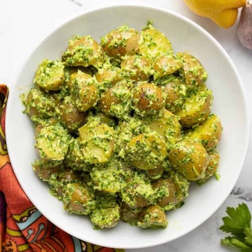 Overhead view of parsley potato salad in a bowl.