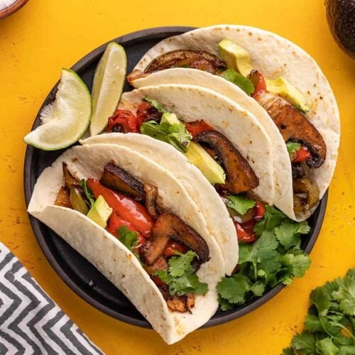 Three portobello fajitas on a plate.