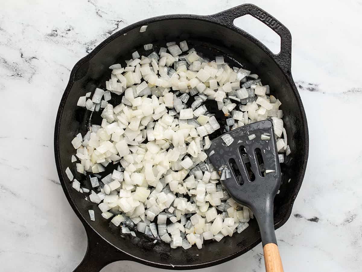 Sautéed onions in a skillet.