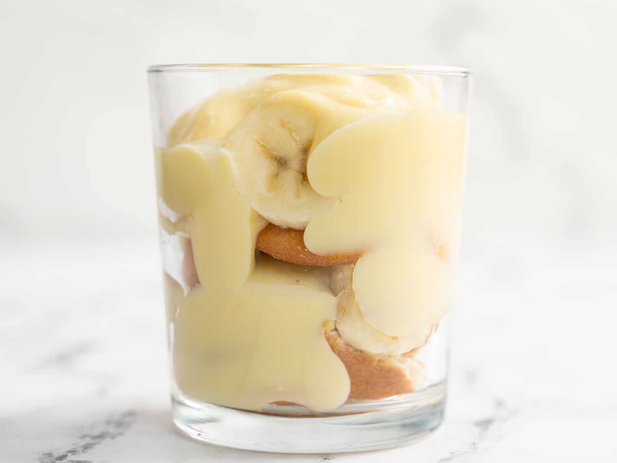 Side view of banana pudding layered in a glass.