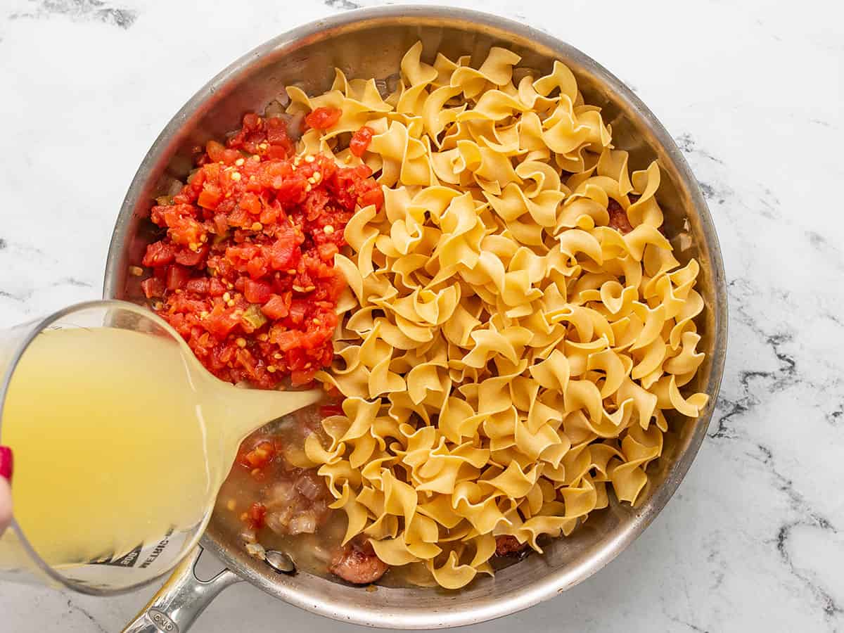 Pasta, tomatoes, and goop widow to the skillet.
