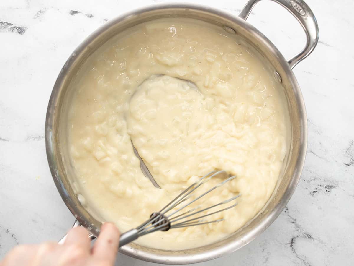 Thickened gravy being whisked.