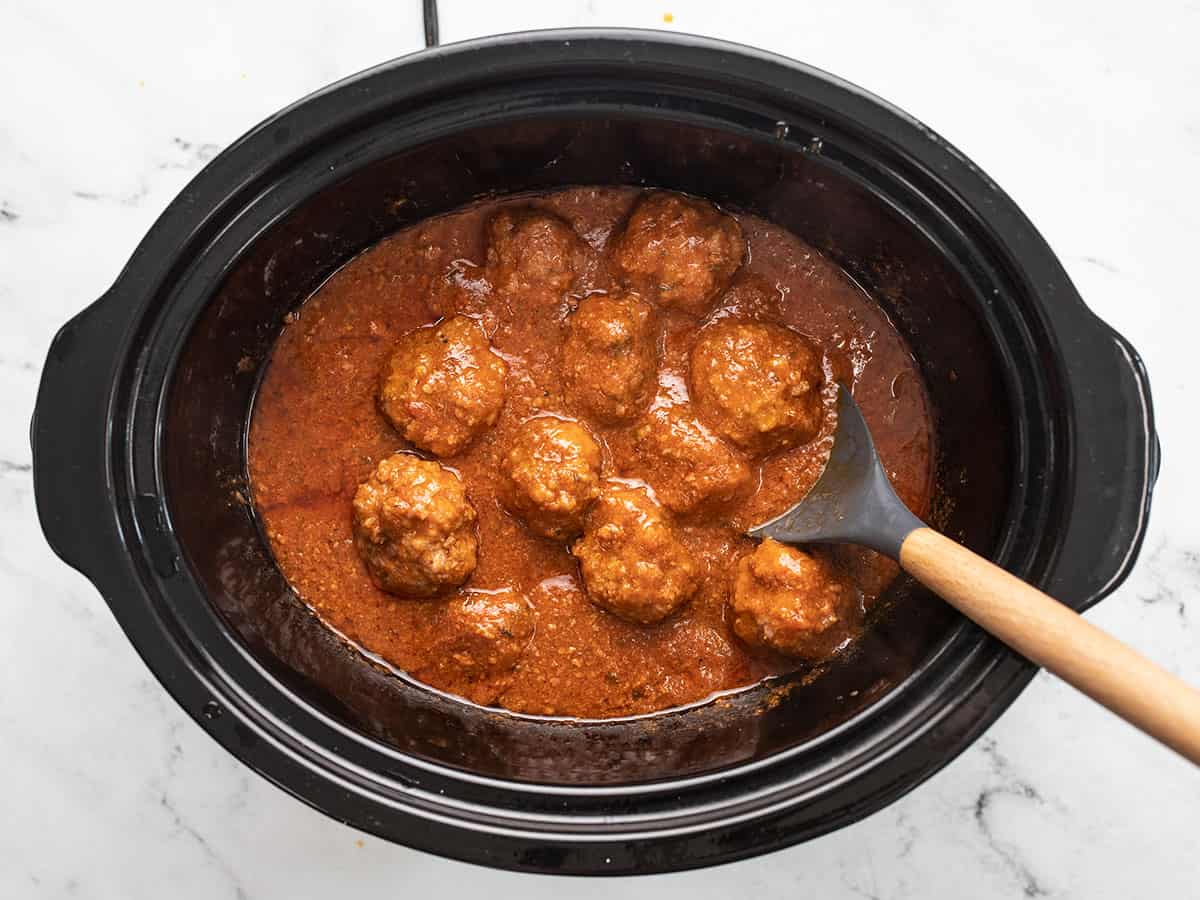 Finished slow cooker meatballs in the slow cooker.