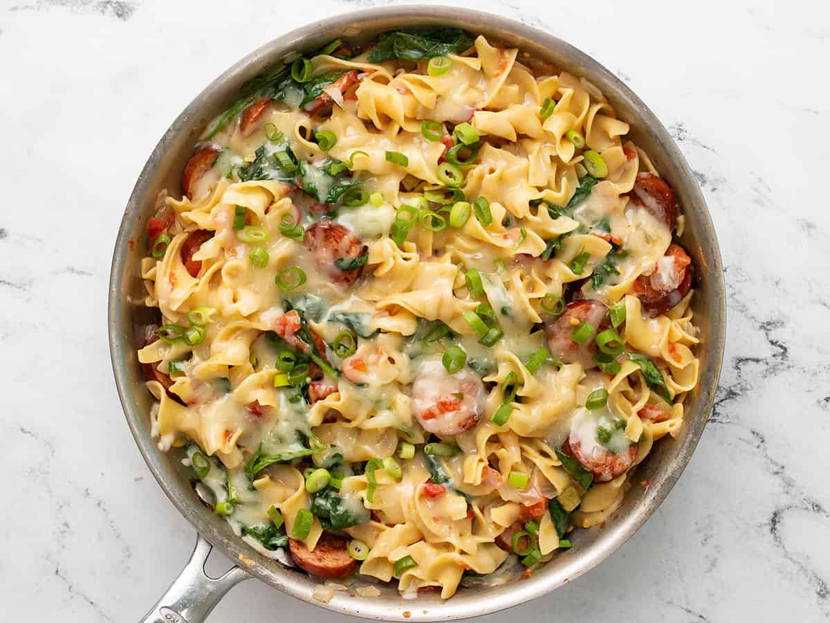 Finished pasta topped with sliced green onions.